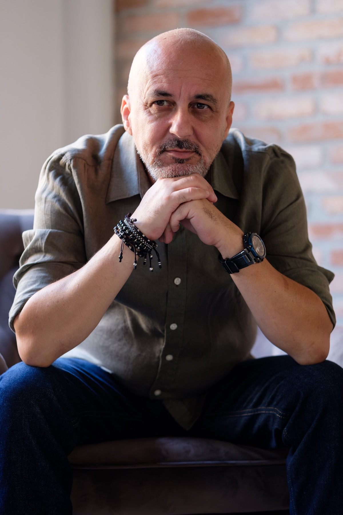 Răzvan Chiru, psiholog și psihoterapeut, așezat în fotoliu în cabinet